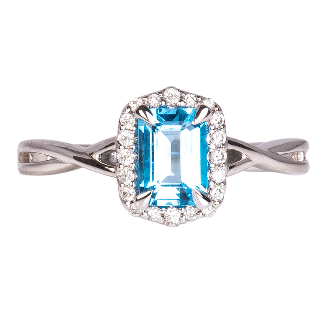 Anillo Topacio Swiss Blue con Halo de Diamantes Nat 0.15qts con Brazos
