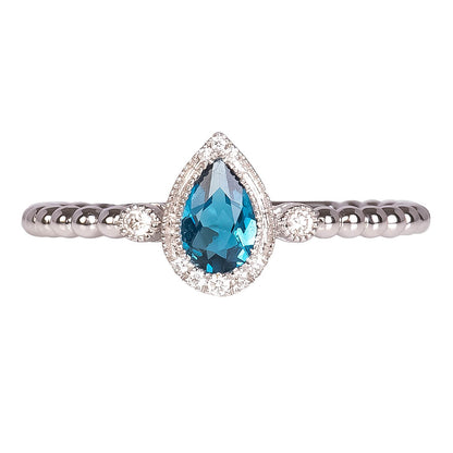 Anillo con Topacio London Blue Corte Pera y Diamantes 0.07qts con Brazos Bolitas