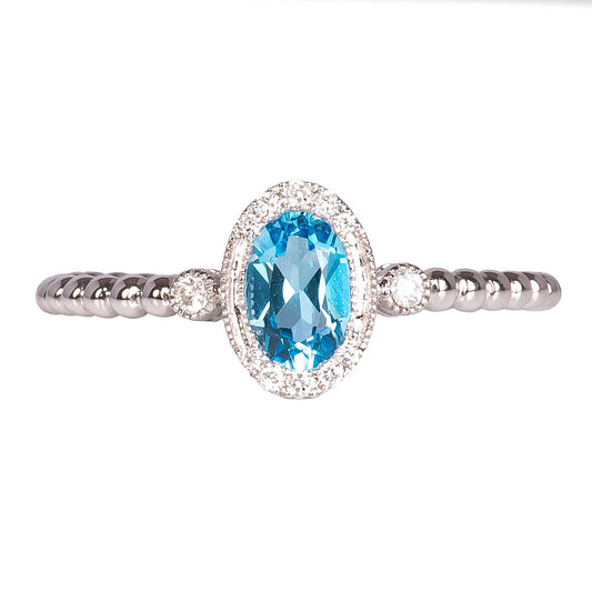 Anillo con Topacio Swiss Blue Corte Oval y Diamantes 0.10qts con Brazos Bolitas